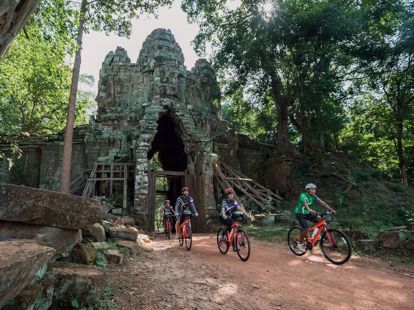 Riding bikes at Angkor Thom Gate
