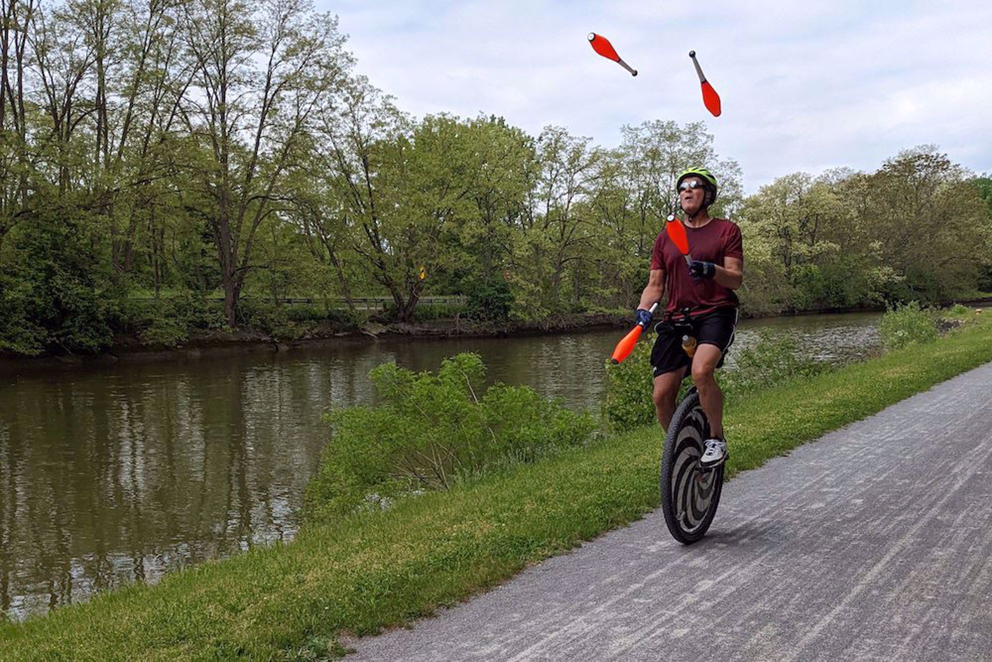 Juggler on Erie Canalway on unicycle