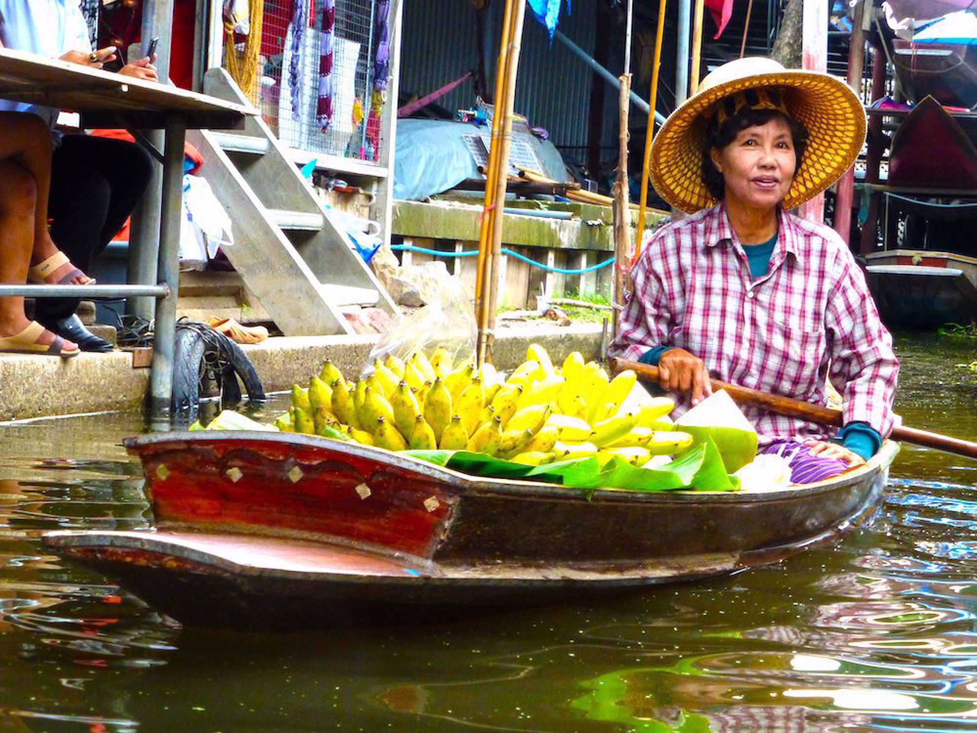 Woman selling fruit from boat in Thailand