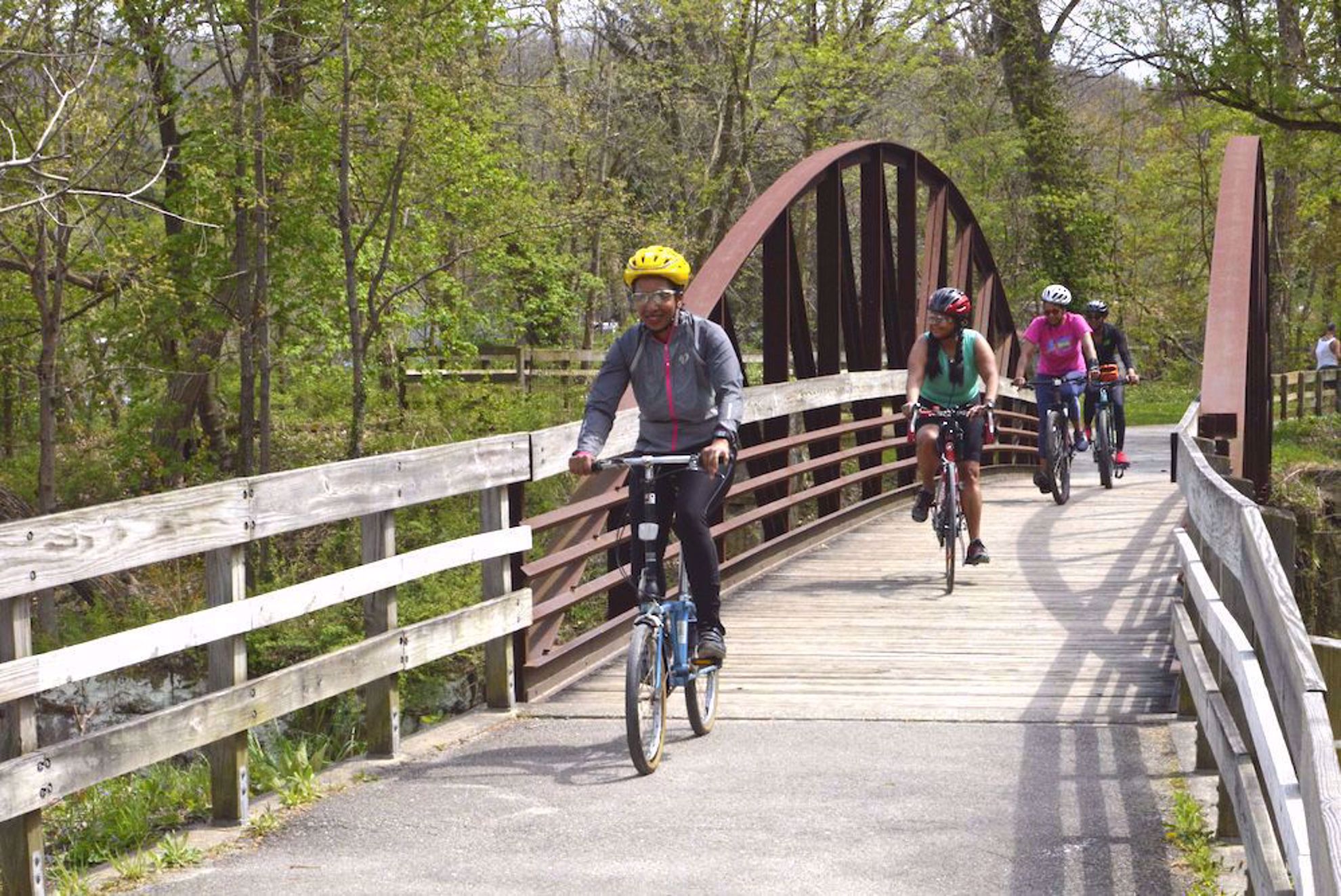 bike riders on bridge in national park